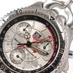 TAG Heuer SEL CG1117 green and red logo close up