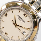 Raymond Weil Tango 5560 logo close up with quarter Roman Numerals