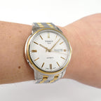 Tissot Automatic III T065430A White dial with gold accents on the wrist