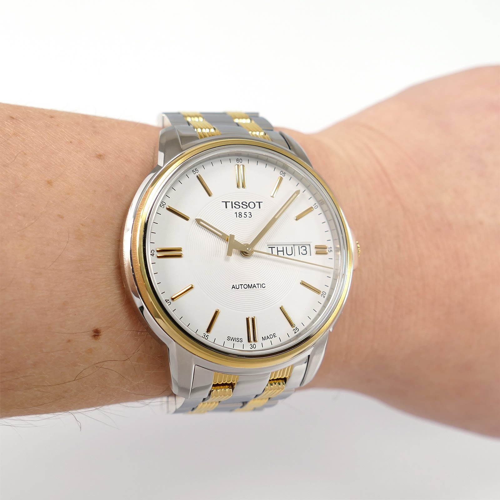 Tissot Automatic III T065430A White dial with gold accents on the wrist