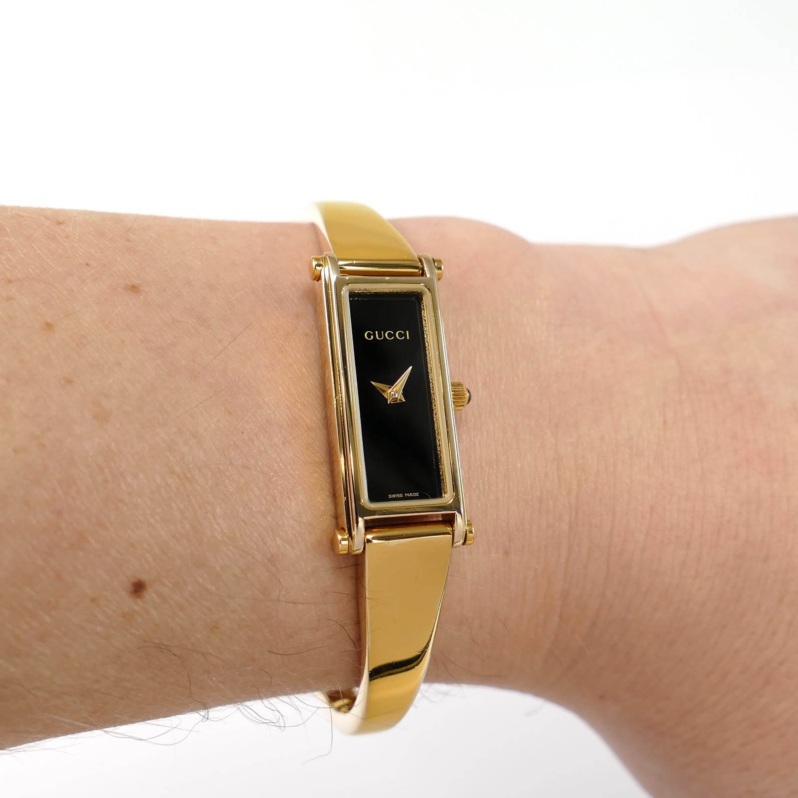 Gucci 1500L Black Dial 18k Gold Plated Bangle on the wrist