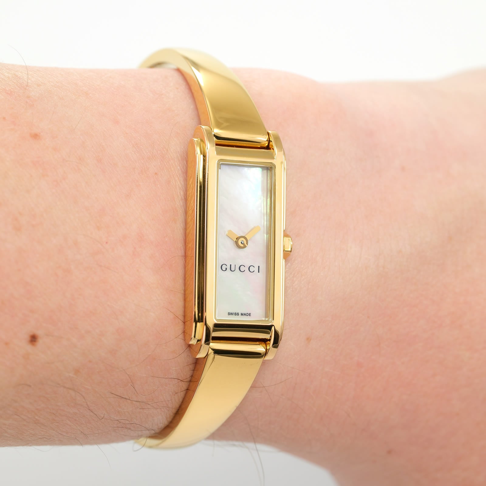Gucci G-Line 109 White Mother of Pearl Dial 18k Gold Plated bangle on the wrist