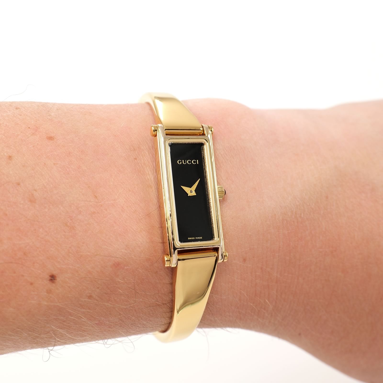 Gucci 1500L Black Dial 18k Gold Plated Bangle on the wrist