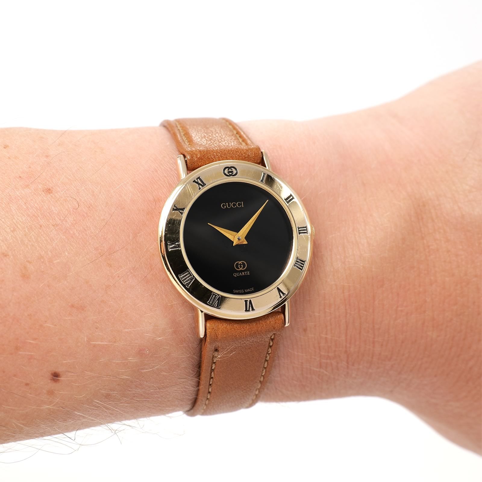 Gucci 3000L Black Dial 18k Gold Plated on Brown Strap on the wrist