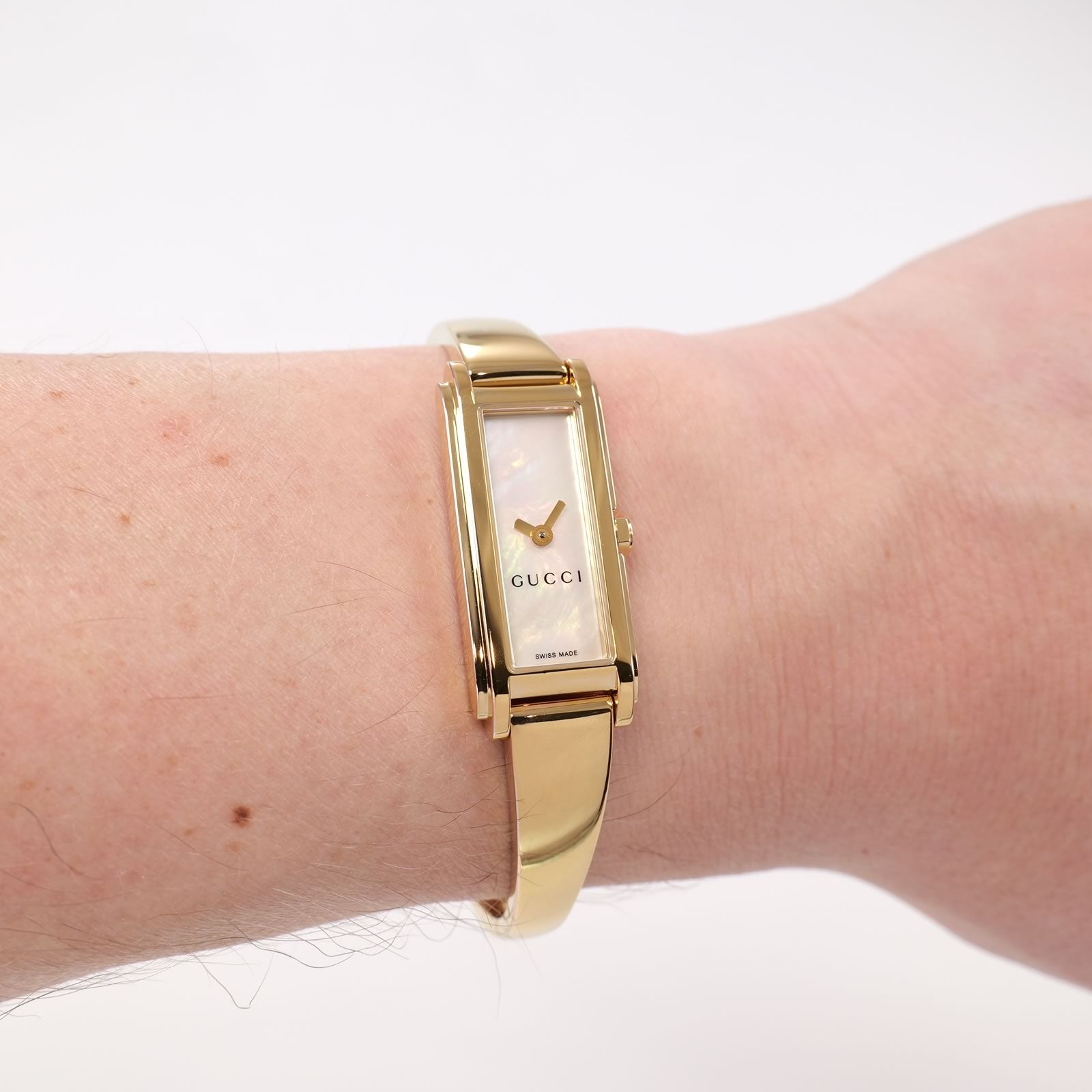 Gucci G-Line 109 White Mother of Pearl Dial 18k Gold Bangle watch on the wrist