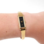 Gucci 1500L Ladies Black Rectangular Dial 18k Gold Plated watch on the wrist