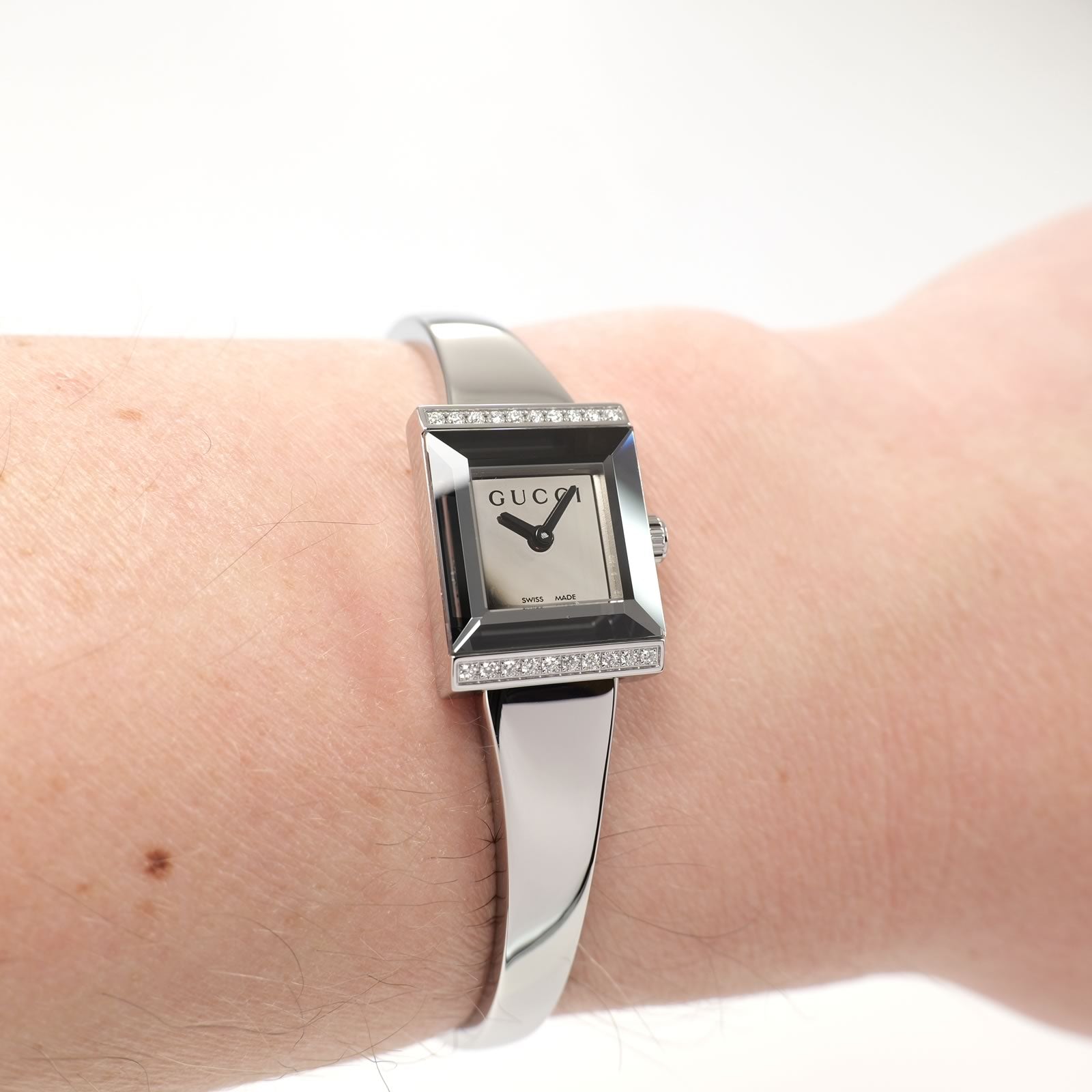 Gucci G-Frame YA128504 Ladies Mirror Dial Square Bangle watch on the wrist
