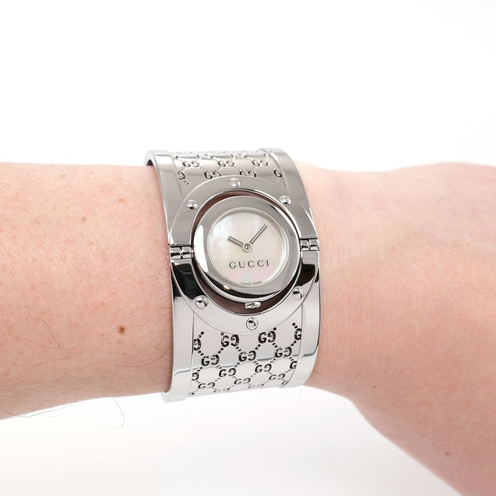 Gucci Twirl 112 Ladies White Mother of Pearl bangle watch on the wrist