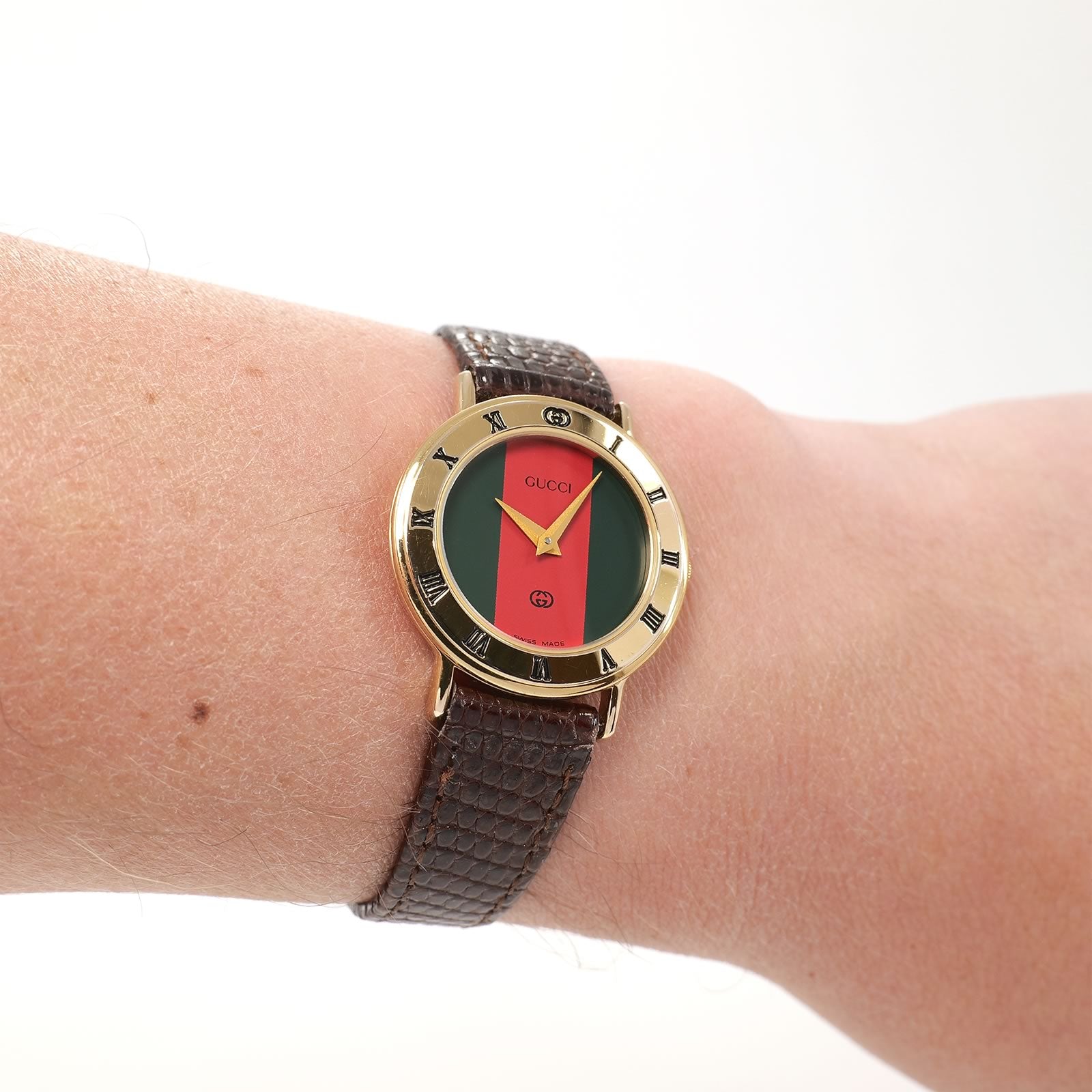 Gucci 3000L Ladies Red and Green Dial 18k Gold Plated watch on the wrist