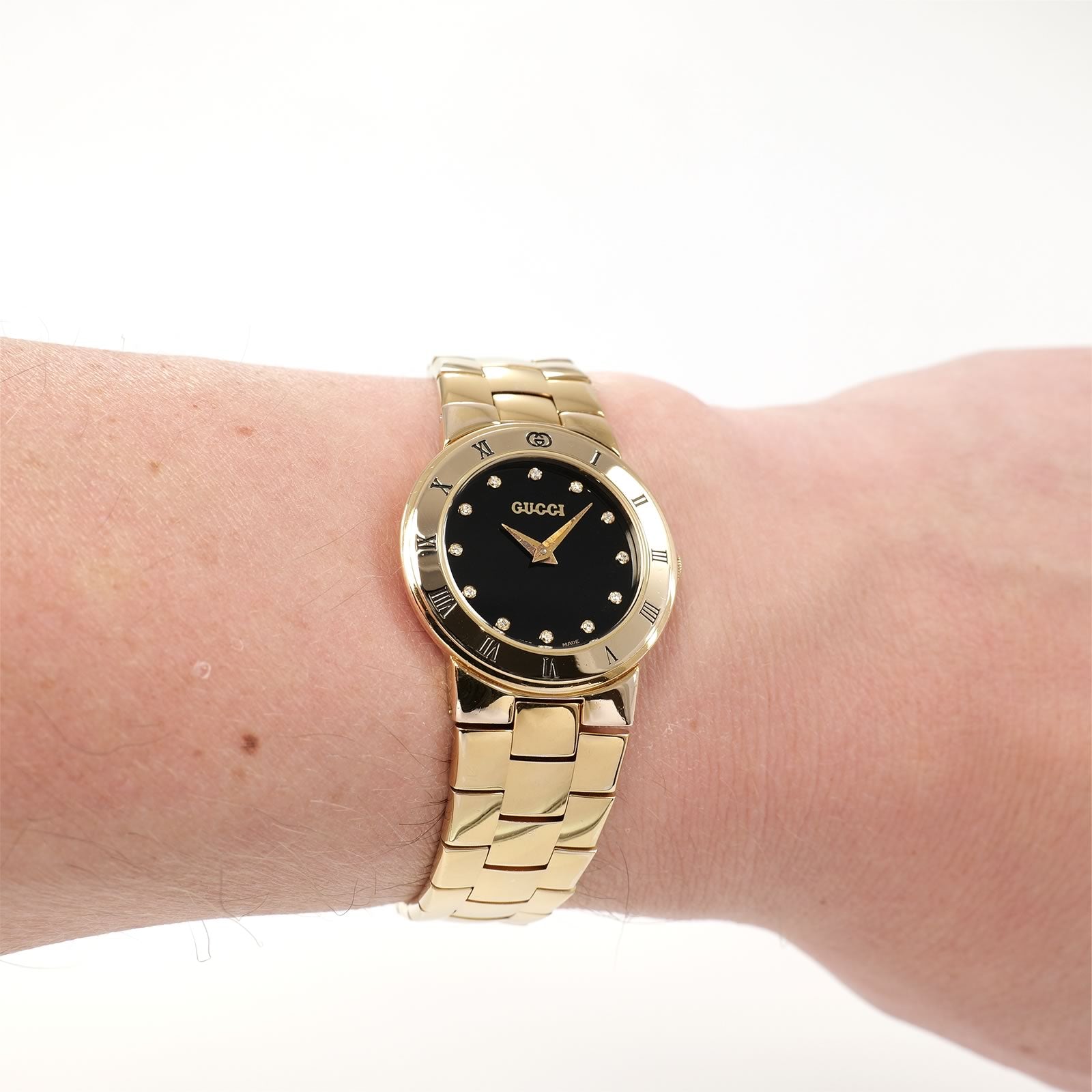 Gucci 3300L Black Dial 18k Gold Plated watch on the wrist