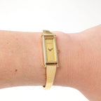 Gucci 1500L Ladies Champagne Dial 18k Gold Plated Bangle watch on the wrist
