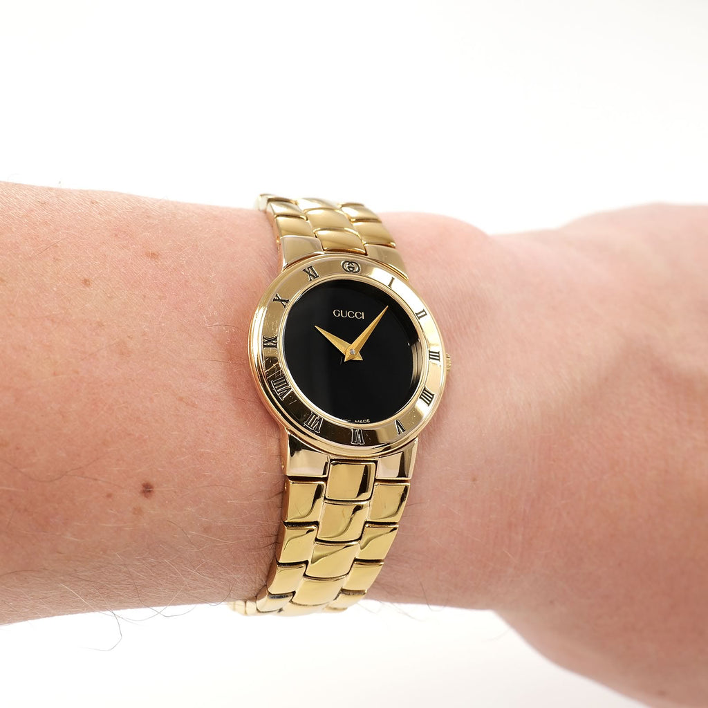 Gucci 3300L Ladies Black Dial 18k Gold Plated watch on the wrist