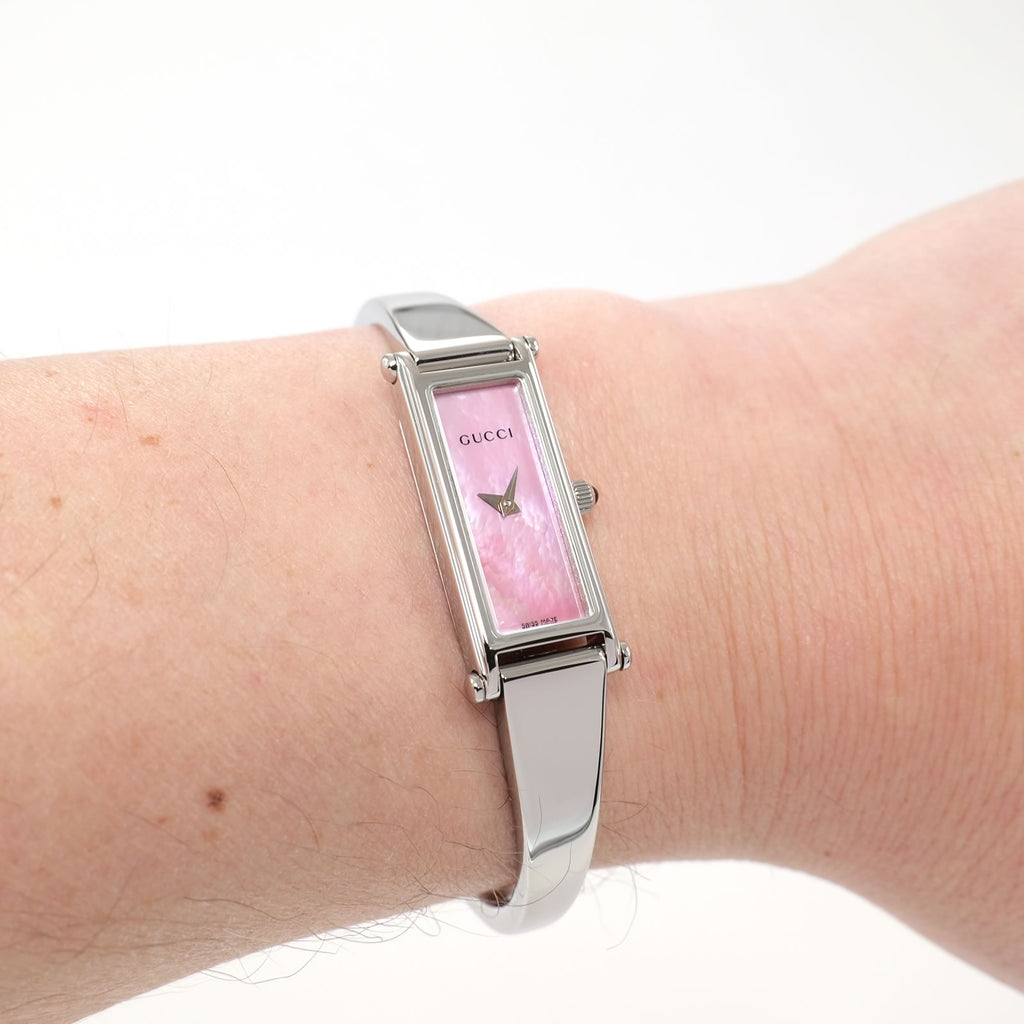 Gucci 1500L Pink Mother of Pearl bangle watch on the wrist