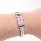 Gucci 1500L Pink Mother of Pearl bangle watch on the wrist