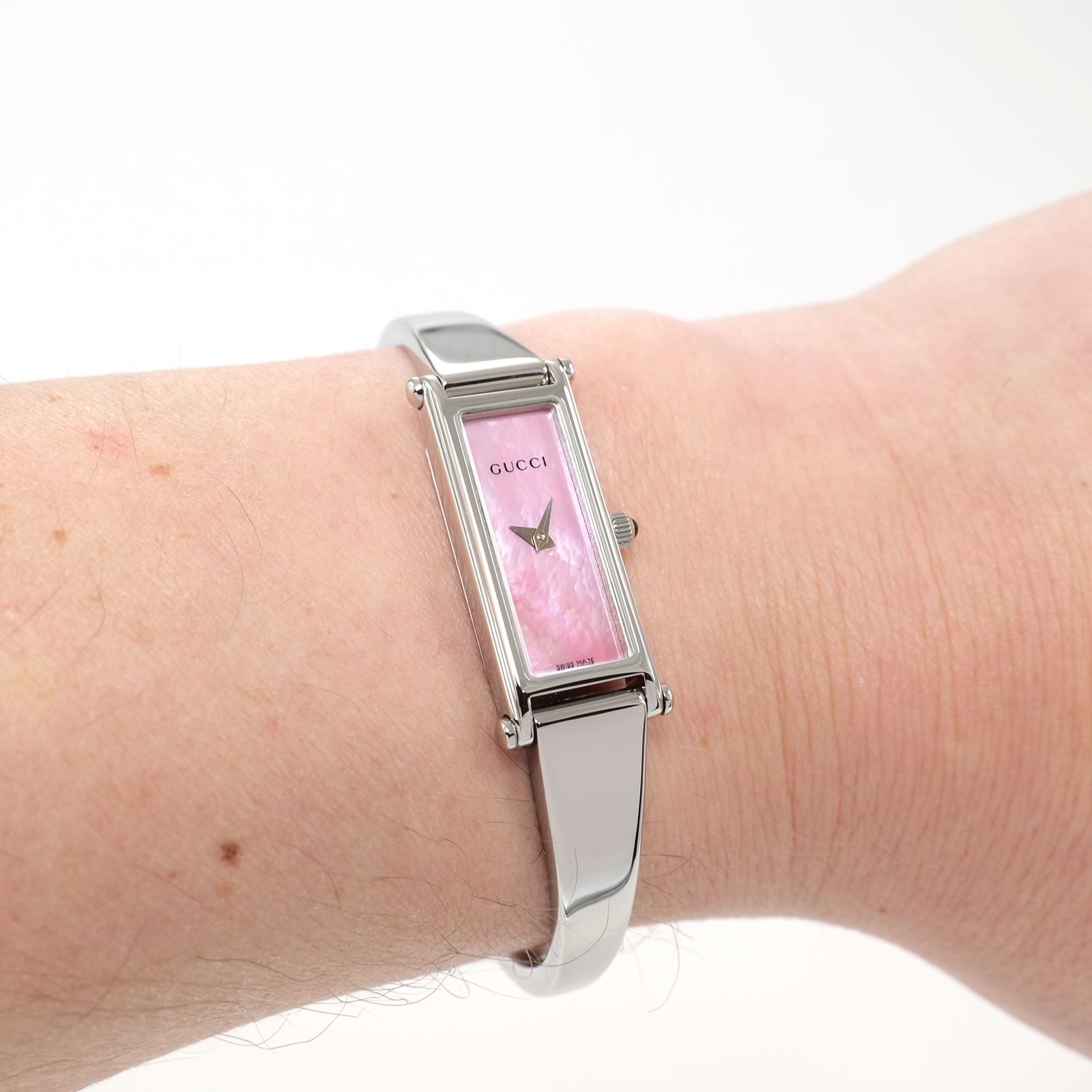 Gucci 1500L Pink Mother of Pearl bangle watch on the wrist