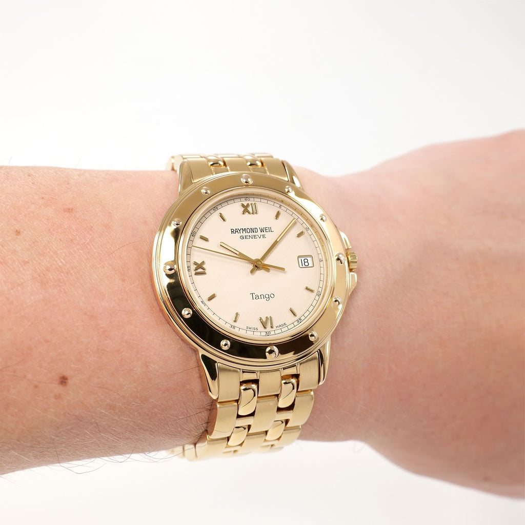 Raymond Weil Tango 5560 Men's Cream Dial 18k Gold Plated watch on the wrist