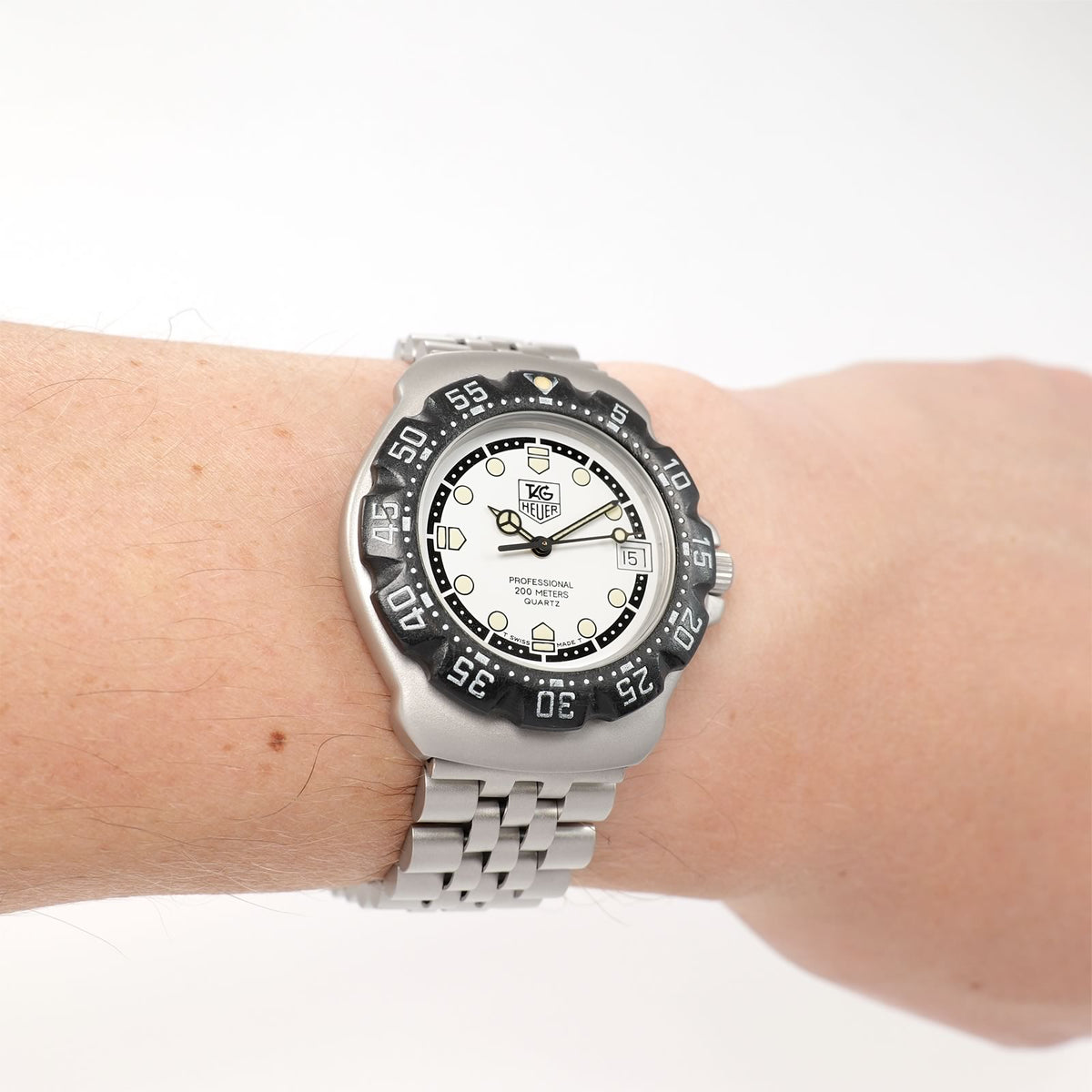TAG Heuer Formula 1 WA1218 Men's White and Black Mid Size watch on the wrist