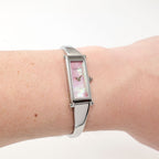 Gucci 1500L Pink Mother of Pearl rectangular bangle watch on the wrist
