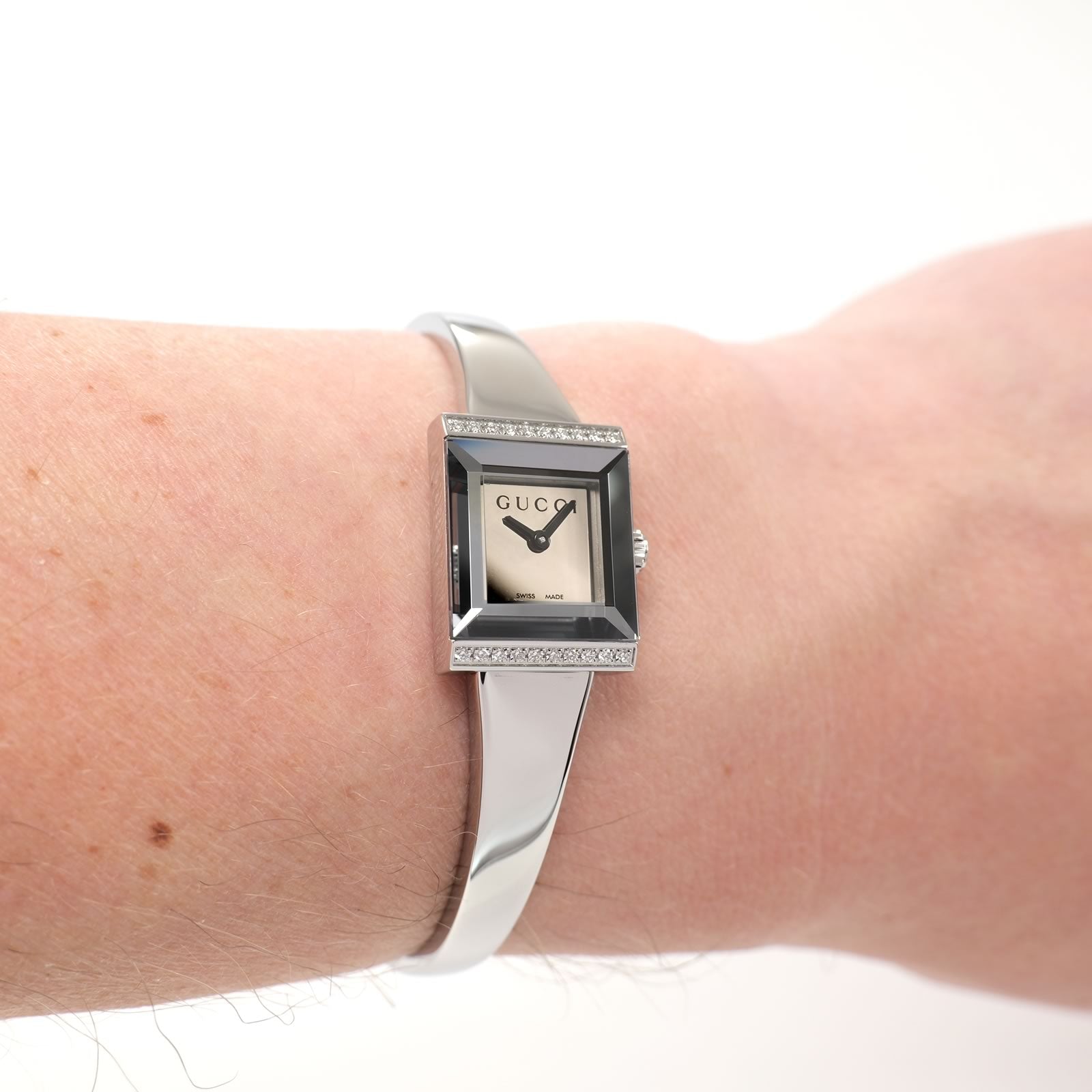 Gucci G-Frame YA128504 Ladies Mirror Dial Square Bangle watch on the wrist