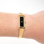 Gucci 1500L Ladies Black Dial 18k Gold Plated watch on the wrist