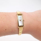 Gucci 1500L Ladies White Mother of Pearl 18k Gold Plated Bangle watch on the wrist