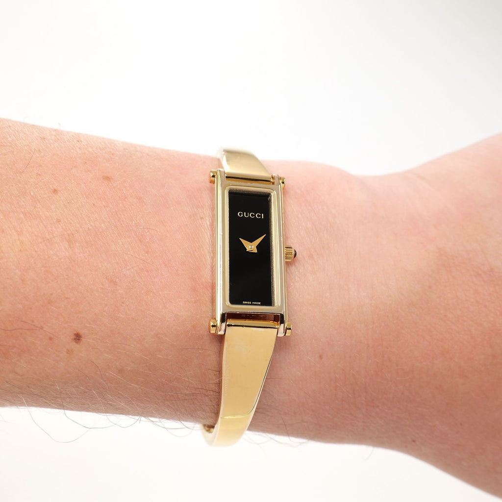 Gucci 1500L Ladies Black Rectangular Dial 18k Gold Plated watch on the wrist