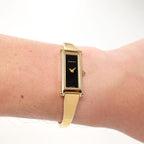 Gucci 1500L Ladies Black Rectangular Dial 18k Gold Plated watch on the wrist