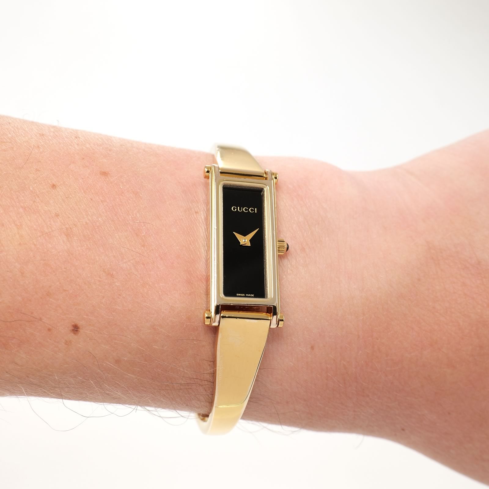 Gucci 1500L Ladies Black Rectangular Dial 18k Gold Plated watch on the wrist