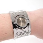 Gucci Twirl 112 Brown Sunburst Dial bangle watch on the wrist