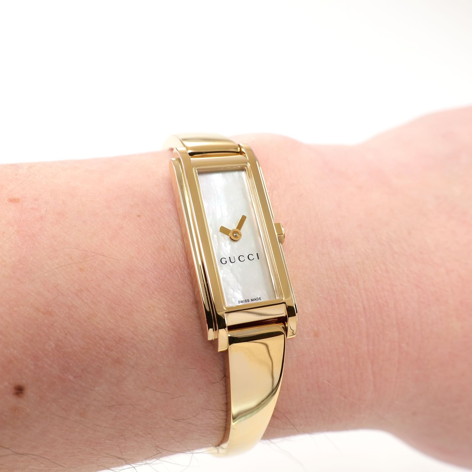Gucci G-Line 109 White Mother of Pearl Dial 18k Gold plated bangle watch on the wrist