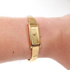 Gucci 1500L Ladies Champagne Dial 18k Gold Plated bangle watch on the wrist
